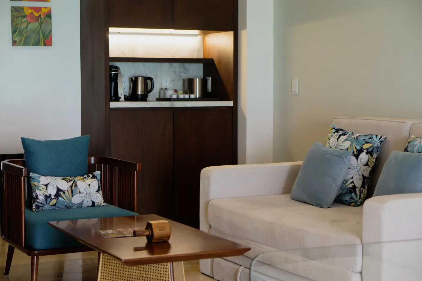 Suite living area with sofa, armchair, coffee table, and wet bar at Sunset Royal Beach Resort.