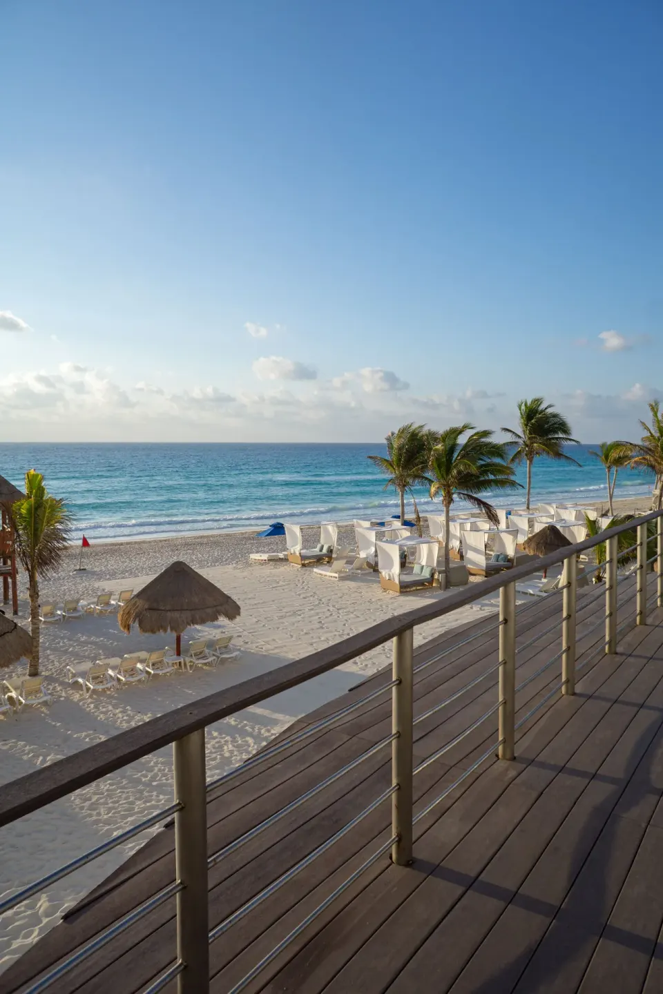 Beach view from a terrace with railing at Sunset Royal Beach Resort.