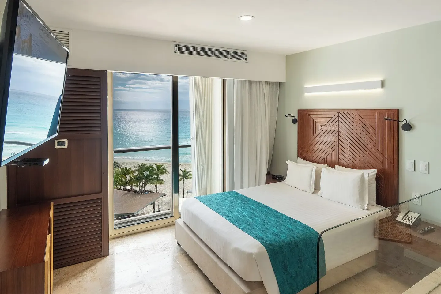 Deluxe Ocean View room with king bed and beach view at Sunset Royal Beach Resort.