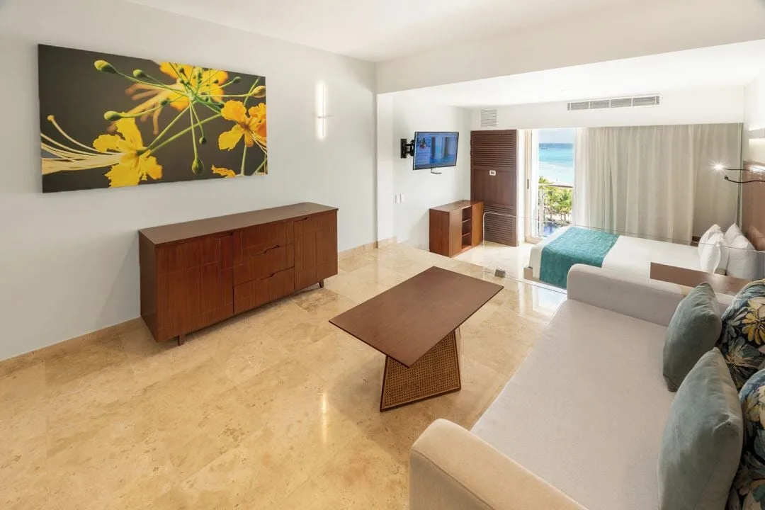 Family Room ocean view living area with sofa and bed at Sunset Royal Beach Resort.