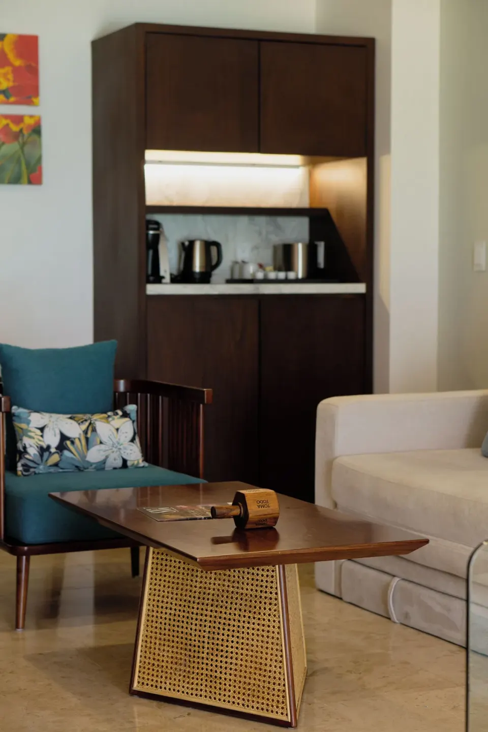 Standard Room sitting area with armchair, sofa, coffee table and cabinet at Sunset Royal Beach Resort.