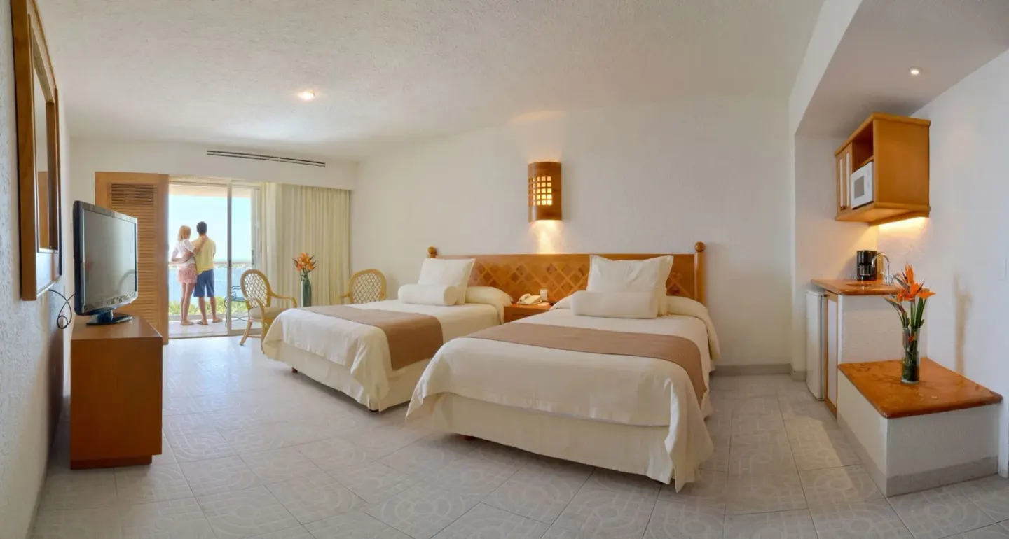 Studio room with two beds, kitchenette, TV and balcony at Sunset Royal Beach Resort.