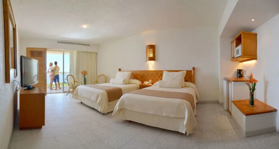Studio room with two beds, kitchenette, TV and balcony at Sunset Royal Beach Resort.