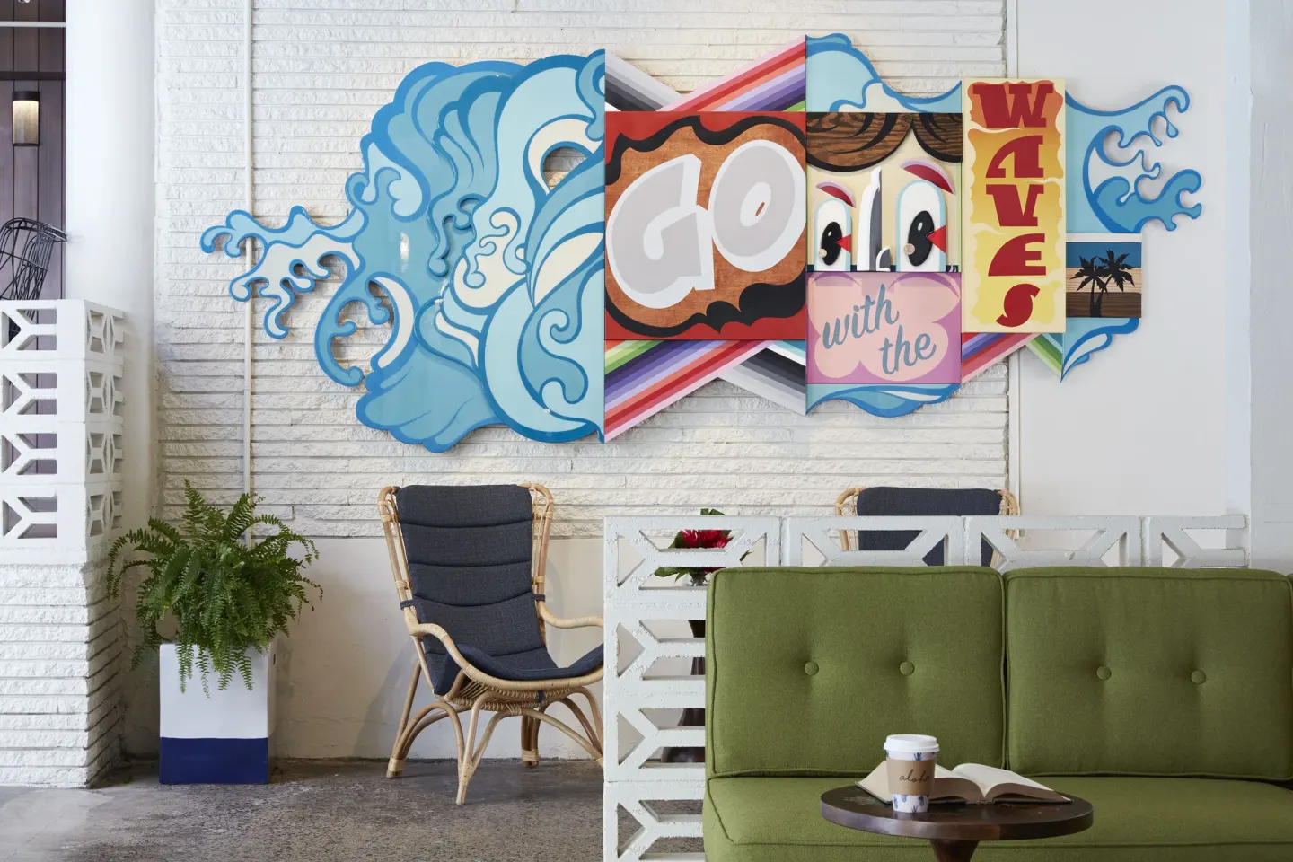 Colorful wave mural and lounge seating at Surfjack Hotel & Swim Club.