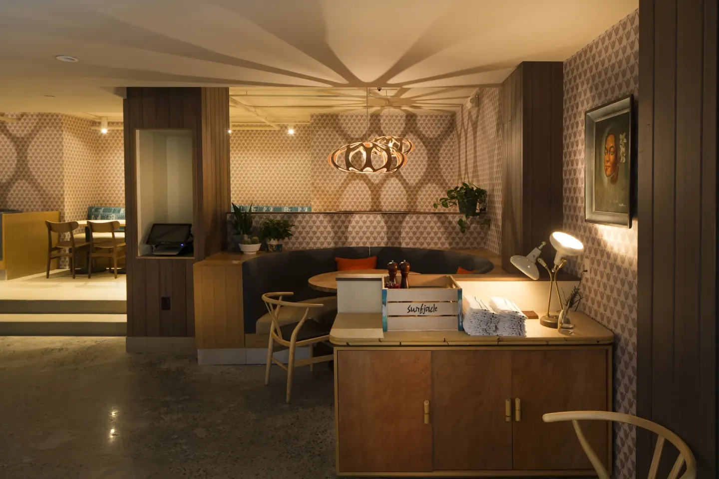 Warm lounge seating and a service counter at Surfjack Hotel & Swim Club.