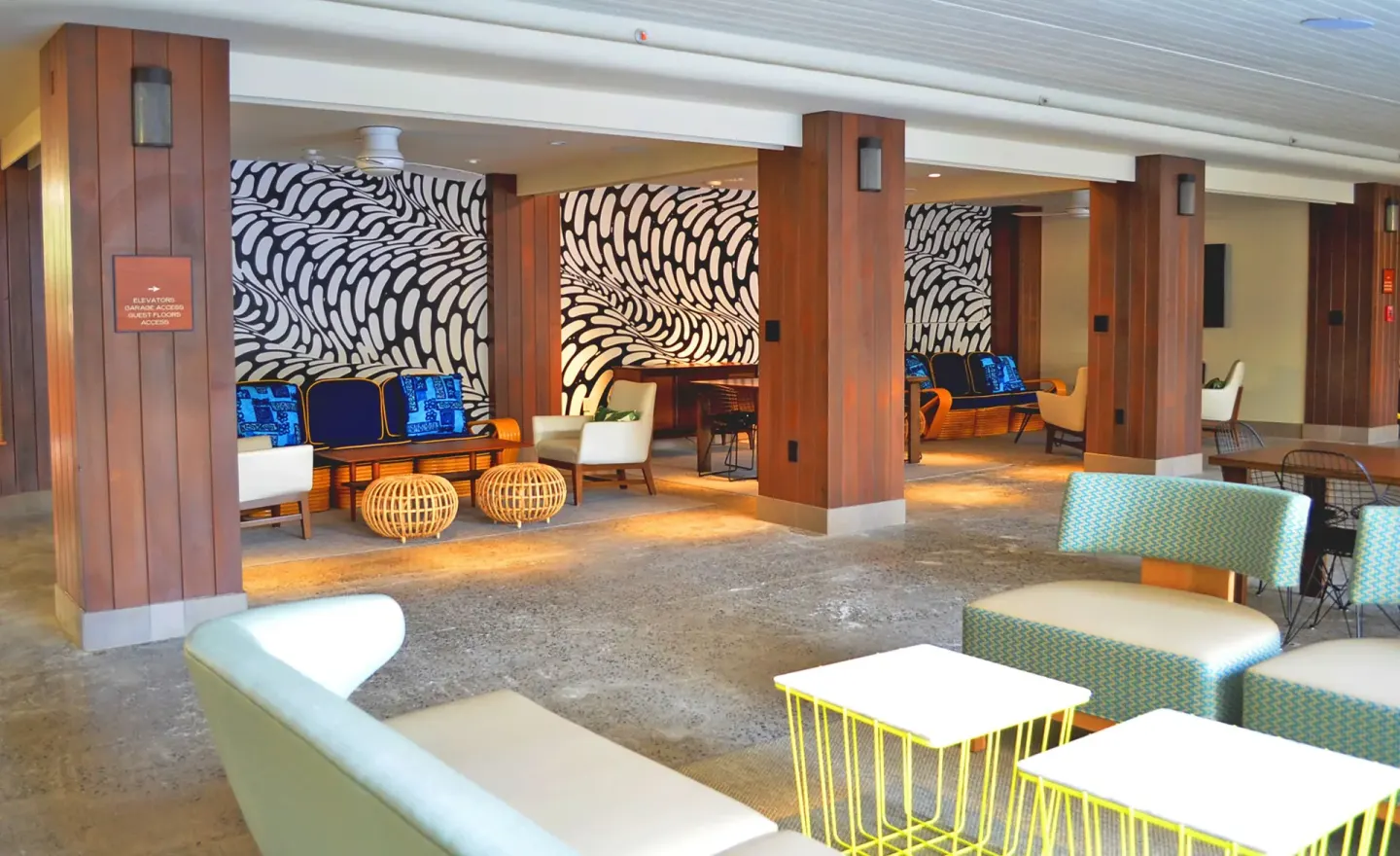 Open lobby seating area with patterned walls at Surfjack Hotel & Swim Club.
