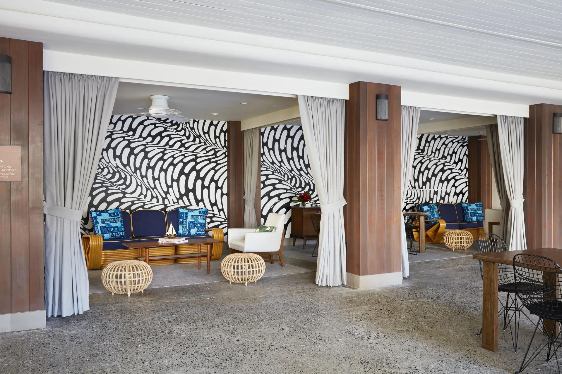 Open lounge alcoves with patterned walls and seating at Surfjack Hotel & Swim Club.