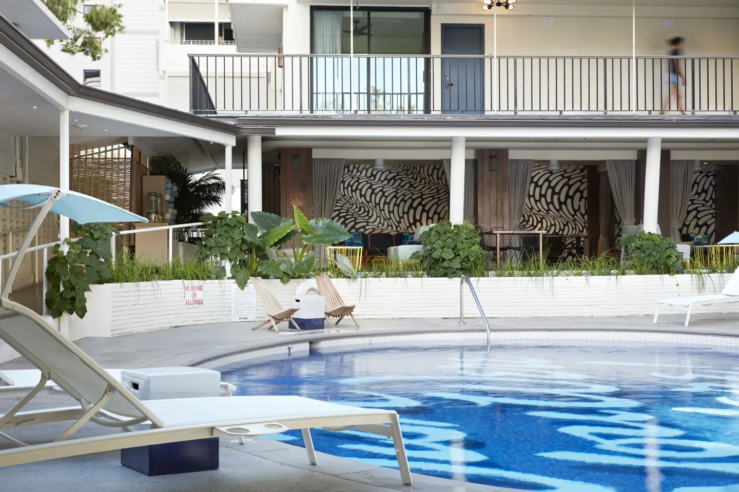Pool deck with loungers and balconies at Surfjack Hotel & Swim Club.