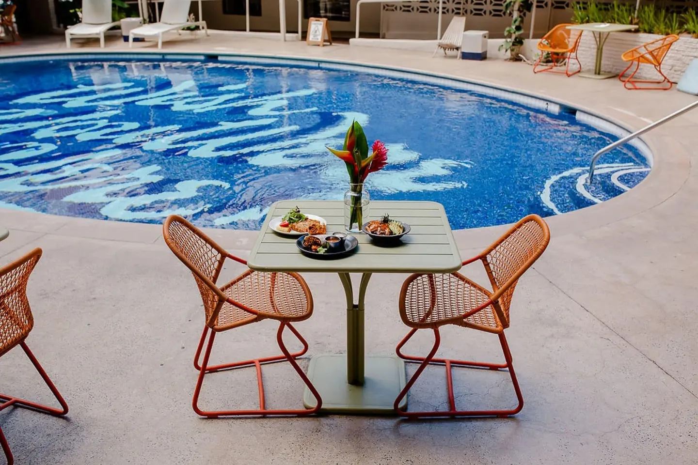 Poolside table with food beside the swimming pool at Surfjack Hotel & Swim Club.