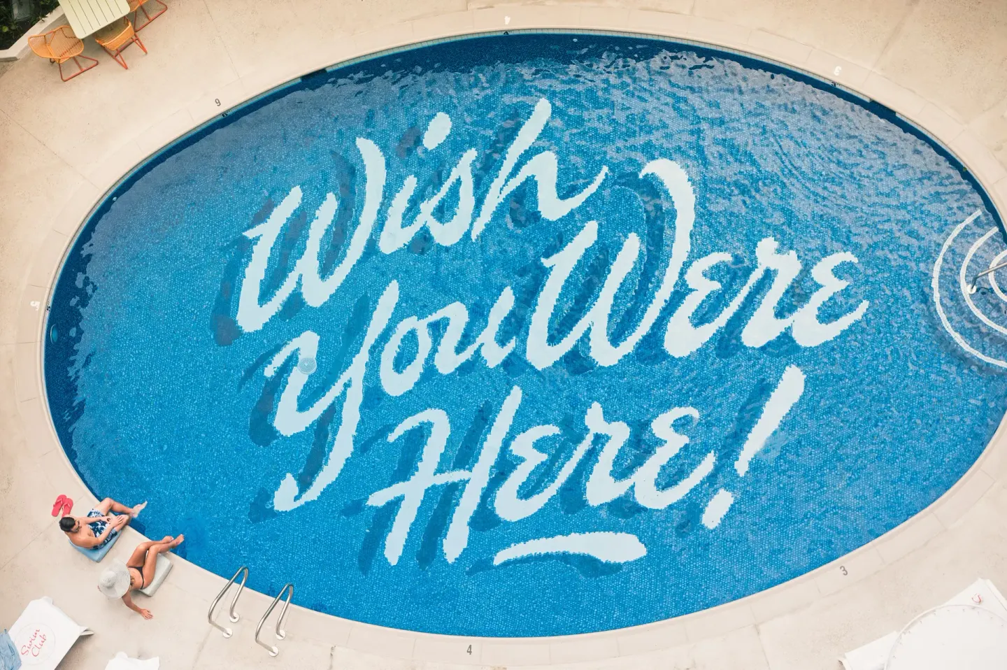 Overhead view of the pool with painted lettering at Surfjack Hotel & Swim Club.
