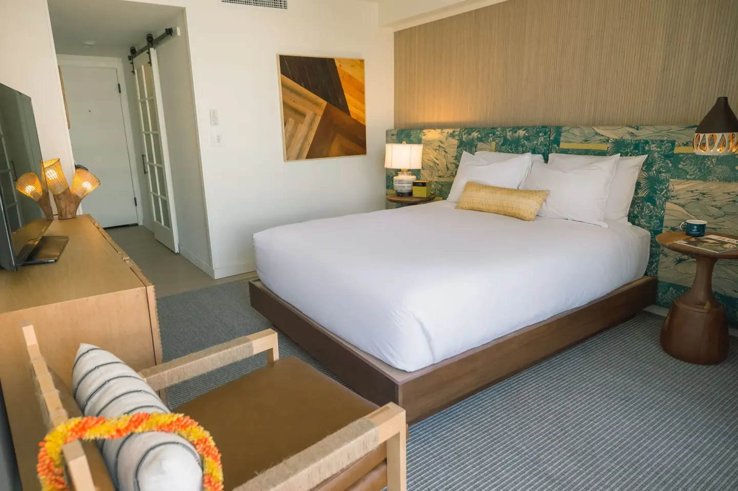 Bungalow king bed guest room with seating at Surfjack Hotel & Swim Club.