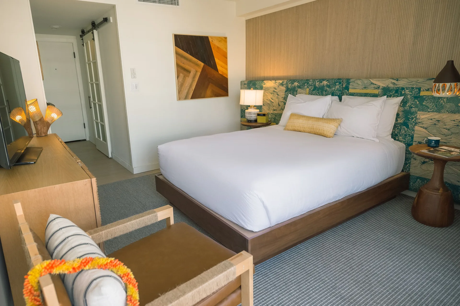 Bungalow king bed guest room with seating at Surfjack Hotel & Swim Club.