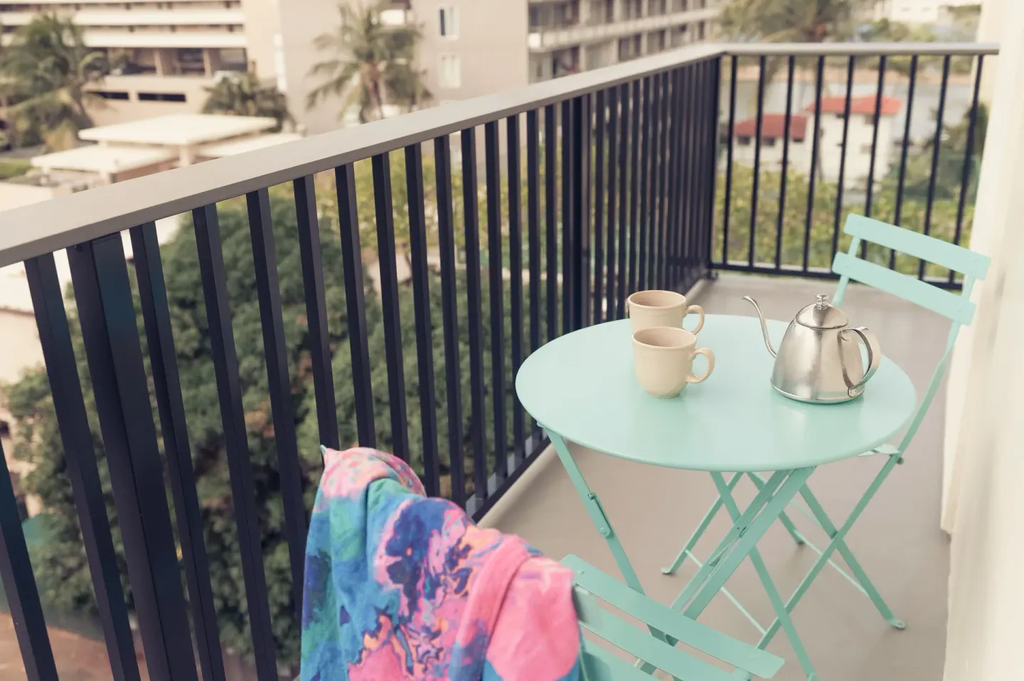 One Room Bungalow balcony with table, chairs and teapot at Surfjack Hotel & Swim Club.