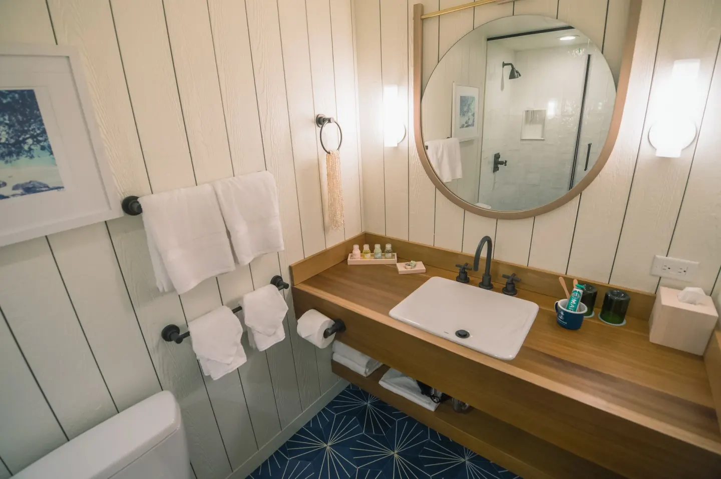 Two-bedroom suite bathroom vanity and round mirror at Surfjack Hotel & Swim Club.