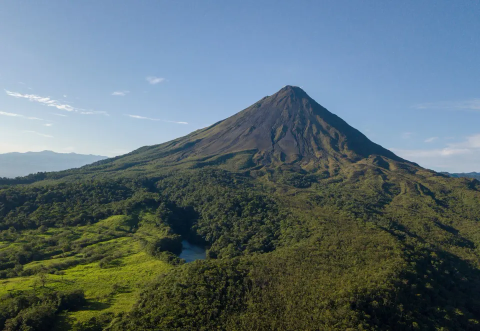 Arenal Volcano towering over green hills near Tabacón Thermal Resort & Spa