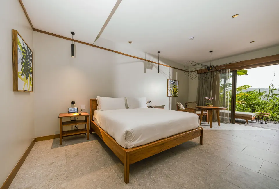 Bright guest room with king bed and balcony at Tabacón Thermal Resort & Spa
