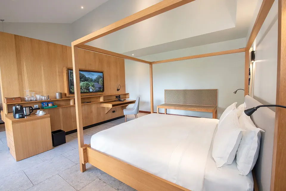 King bed and media console in guest room at Tabacón Thermal Resort & Spa