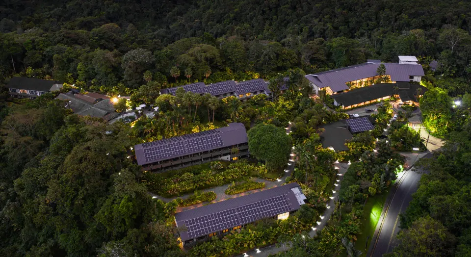 Aerial nighttime view of Tabacón Thermal Resort & Spa illuminated among rainforest