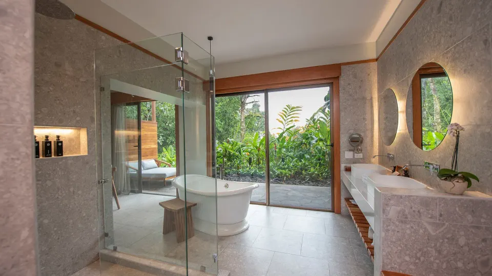 Spacious bathroom with freestanding tub and glass shower at Tabacón Thermal Resort & Spa