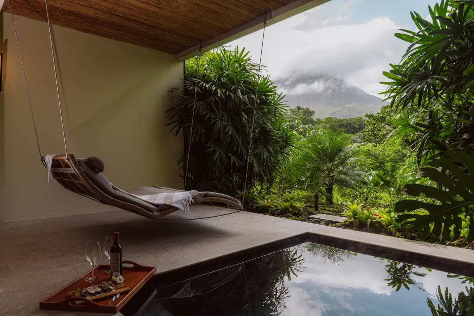 Private terrace with plunge pool, hammock and tray with wine and snacks at Tabacón Thermal Resort & Spa