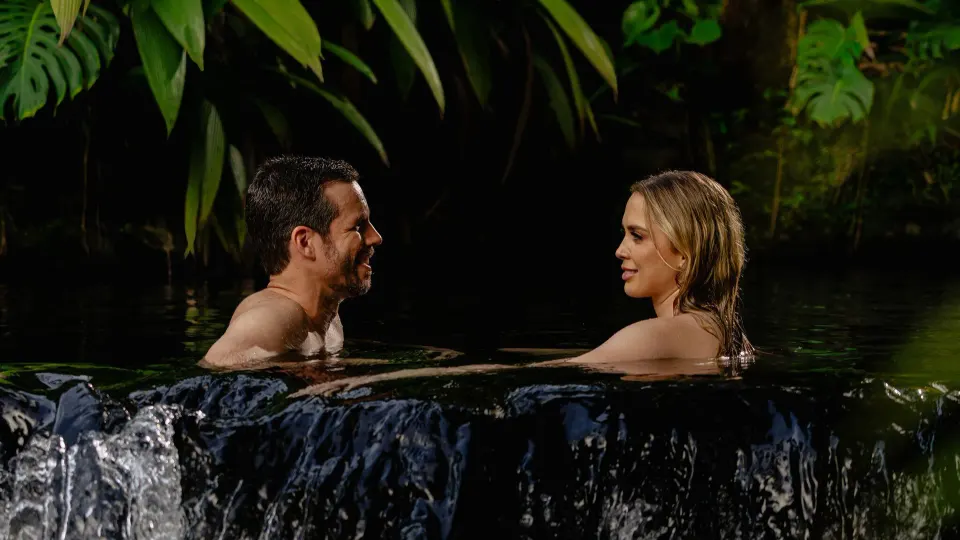 Two guests relaxing in a dark thermal pool at Tabacón Thermal Resort & Spa