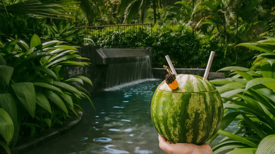 Watermelon drink held near a tropical stream at Tabacón Thermal Resort & Spa
