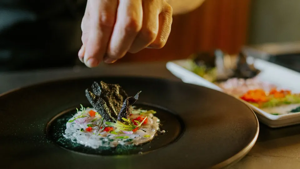 Chef finishing a plated gourmet dish at Tabacón Thermal Resort & Spa