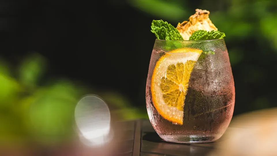 Close-up cocktail with orange slice and mint at Tabacón Thermal Resort & Spa
