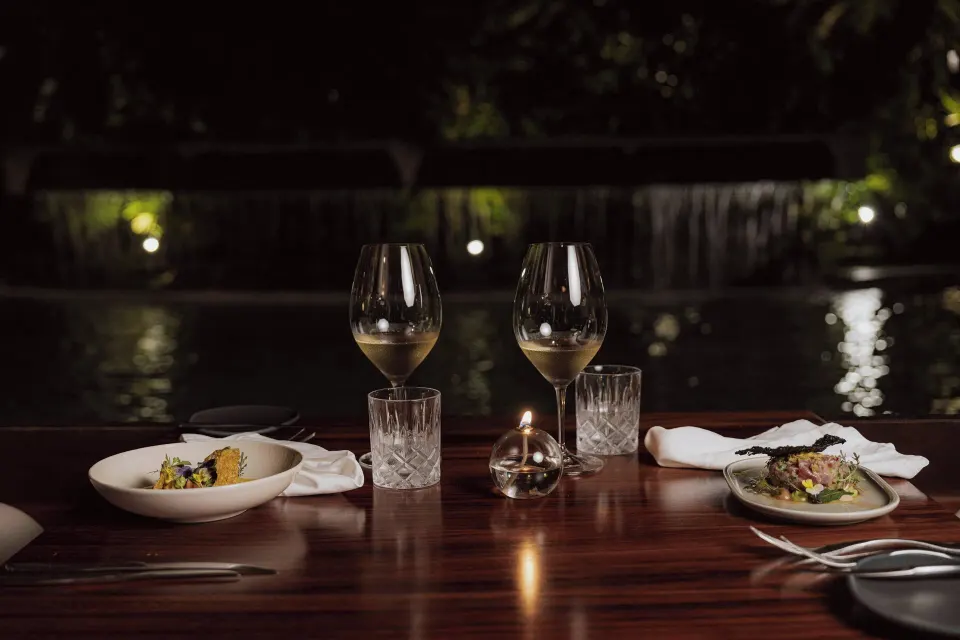 Romantic table for two with wine and waterfall at Tabacón Thermal Resort & Spa