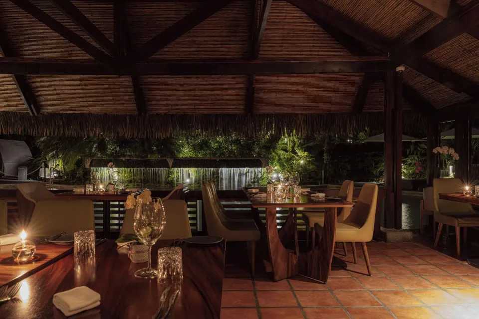 Open-air restaurant dining room with waterfall view at Tabacón Thermal Resort & Spa