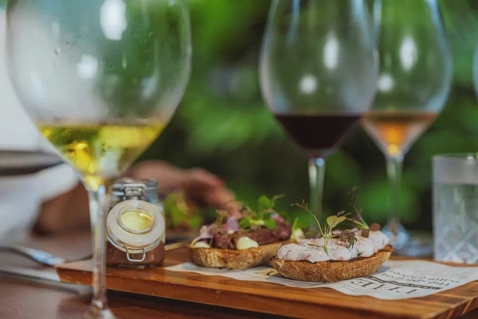 Appetizer board and wine glasses on a table at Tabacón Thermal Resort & Spa