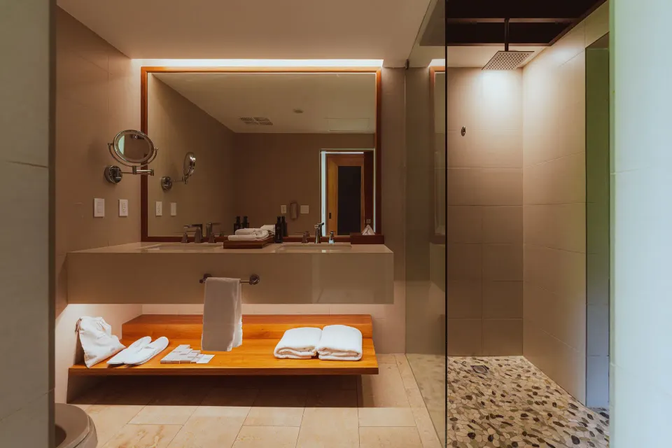 Orchid Room bathroom with large mirror and walk-in shower at Tabacón Thermal Resort & Spa