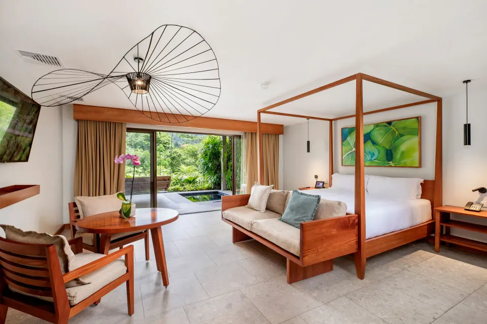 Bright Private Pool Suite interior with four-poster bed and seating at Tabacón Thermal Resort & Spa