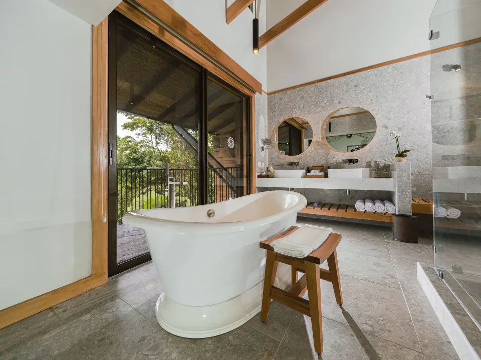 Freestanding bathtub and dual sinks in Rainforest King bathroom at Tabacón Thermal Resort & Spa