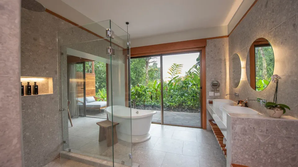 Bathtub, glass shower and vanity in Rainforest King bathroom at Tabacón Thermal Resort & Spa