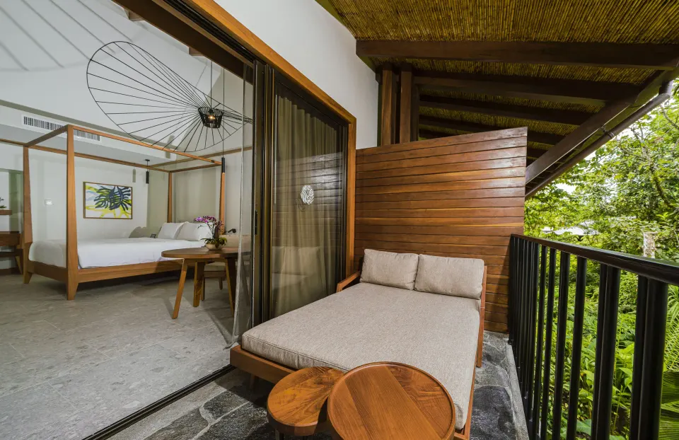 Patio daybed and sliding glass doors from Rainforest King Bed Room at Tabacón Thermal Resort & Spa