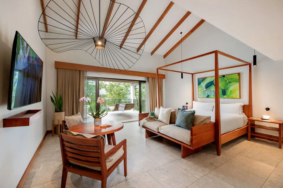 Volcano View Suite interior with four-poster king bed and seating at Tabacón Thermal Resort & Spa