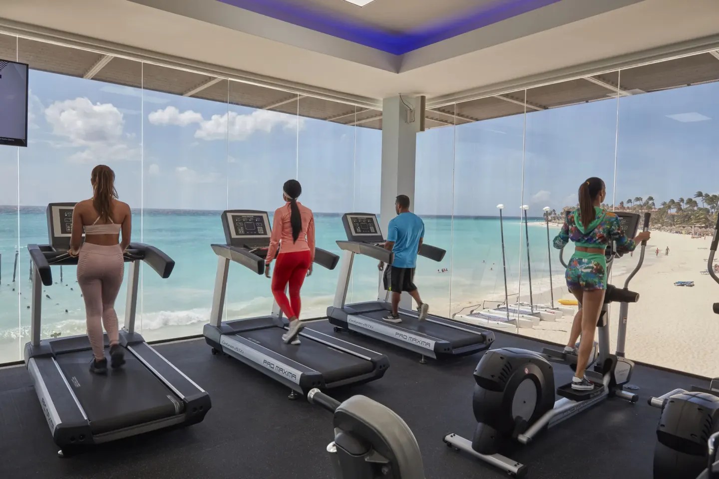 Fitness room with treadmills and beach views at Tamarijn Aruba.