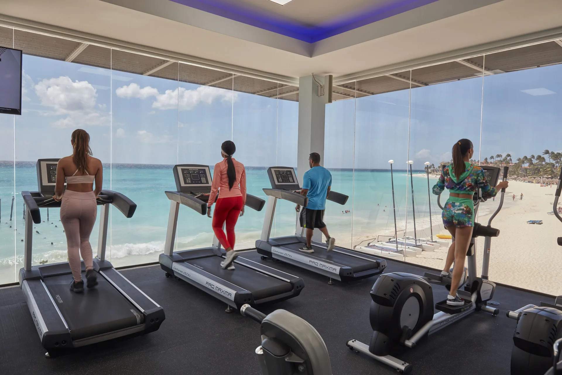 Fitness room with treadmills and beach views at Tamarijn Aruba.