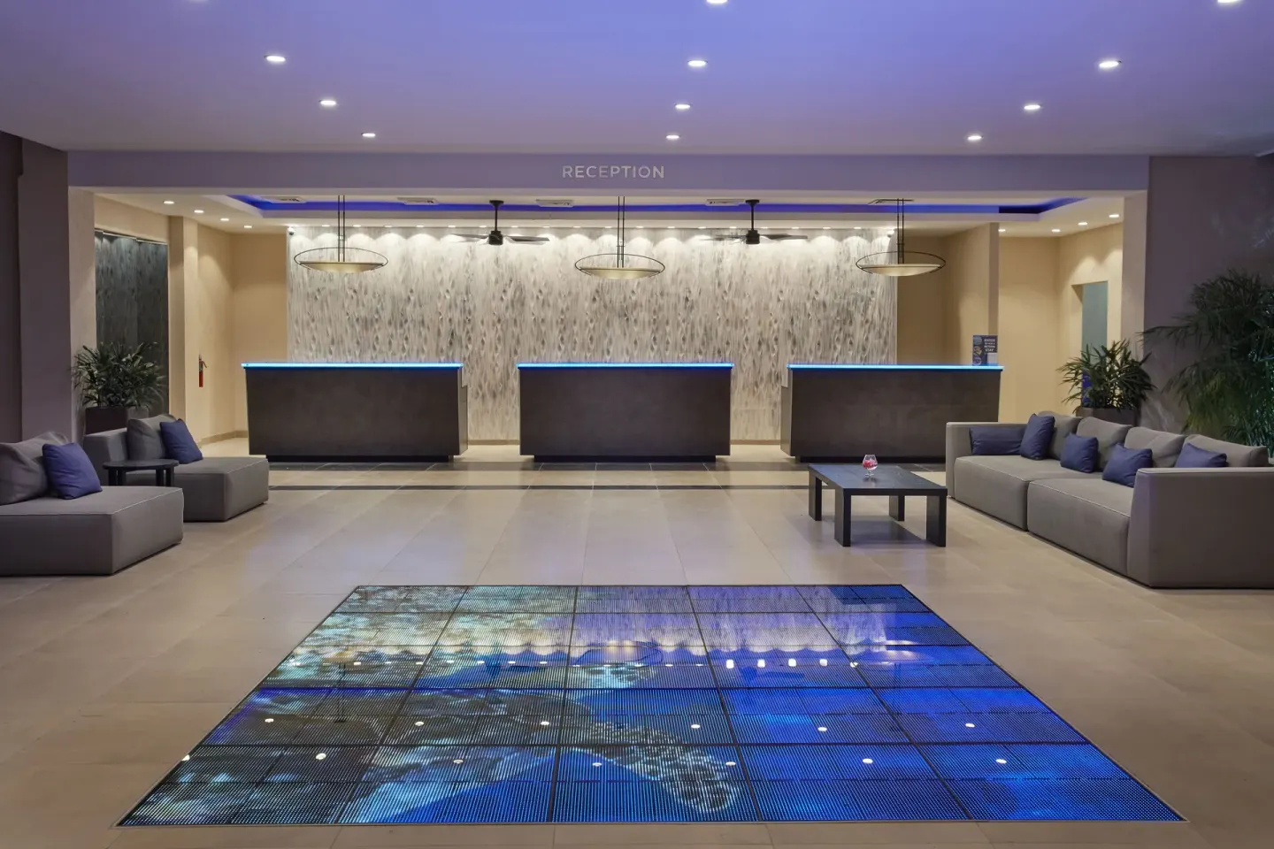 Reception lobby with front desks and lounge seating at Tamarijn Aruba.