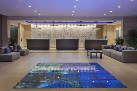 Reception lobby with front desks and lounge seating at Tamarijn Aruba.