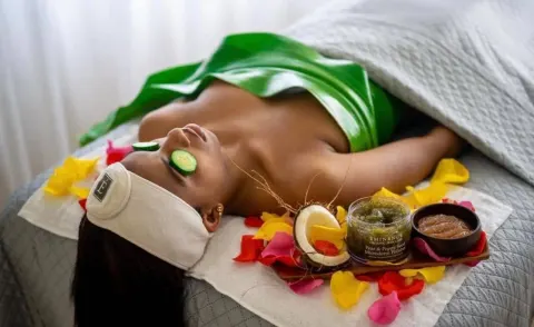 Spa facial setup with cucumber slices and flower petals at Tamarijn Aruba.