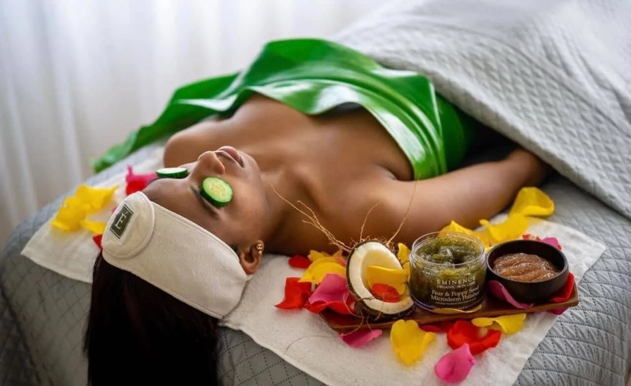 Spa facial setup with cucumber slices and flower petals at Tamarijn Aruba.