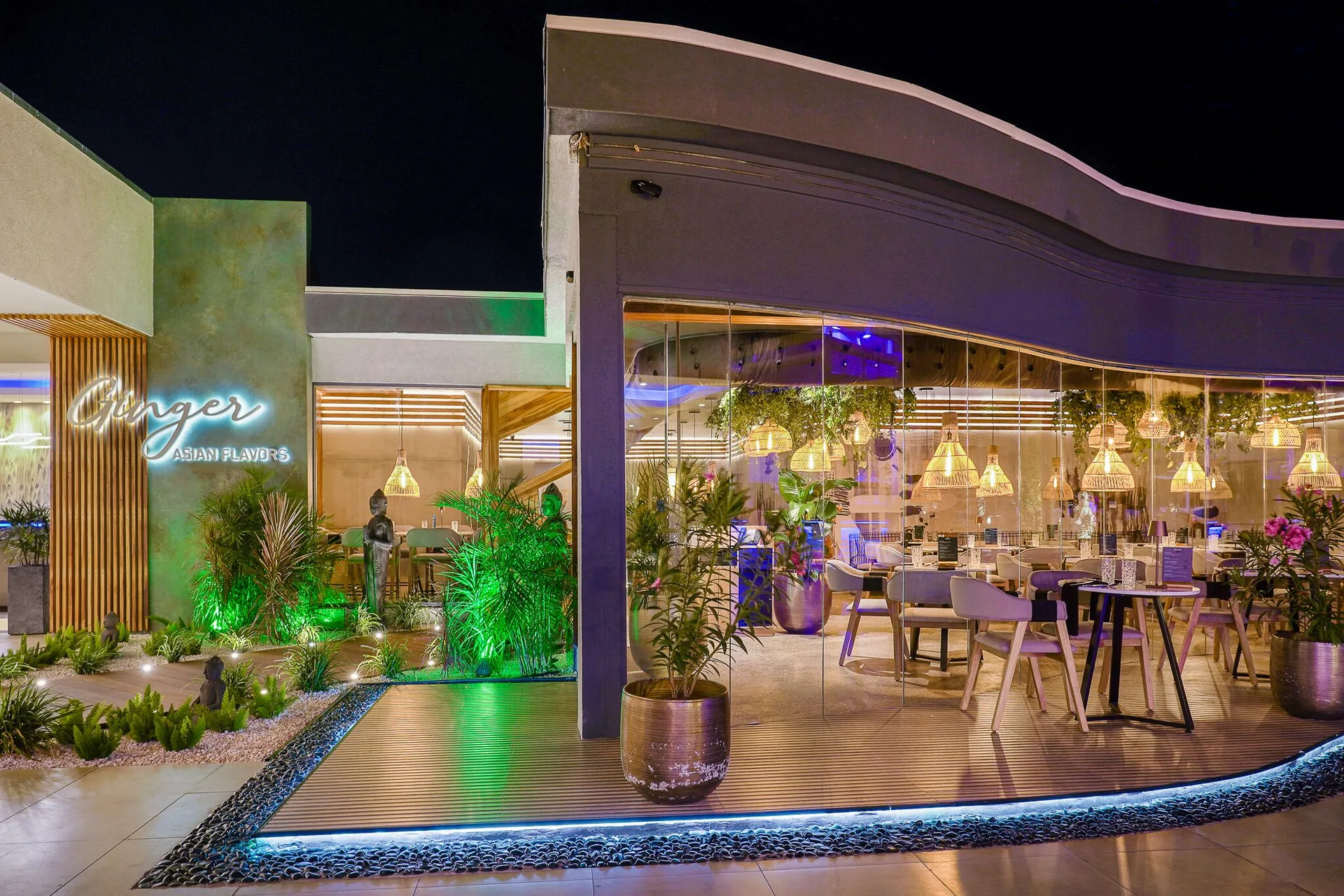 Ginger restaurant exterior with glass walls and night lighting at Tamarijn Aruba.