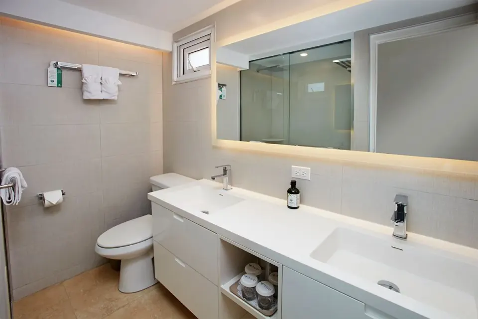 Deluxe Oceanfront bathroom vanity with two sinks and mirror at Tamarijn Aruba.