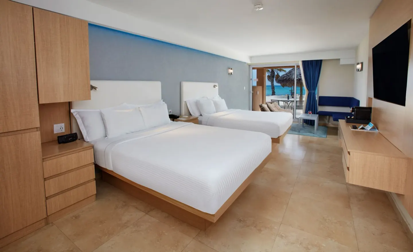 Premium Oceanfront Room with two beds and patio view at Tamarijn Aruba.