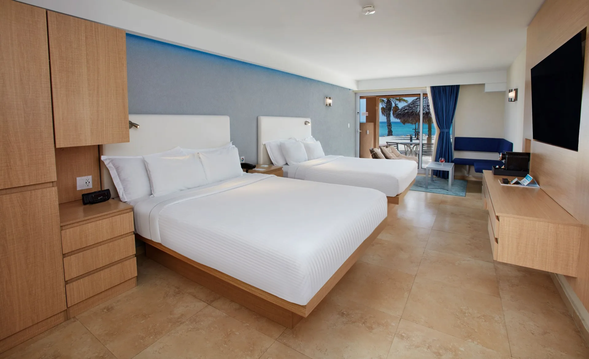 Premium Oceanfront Room with two beds and patio view at Tamarijn Aruba.