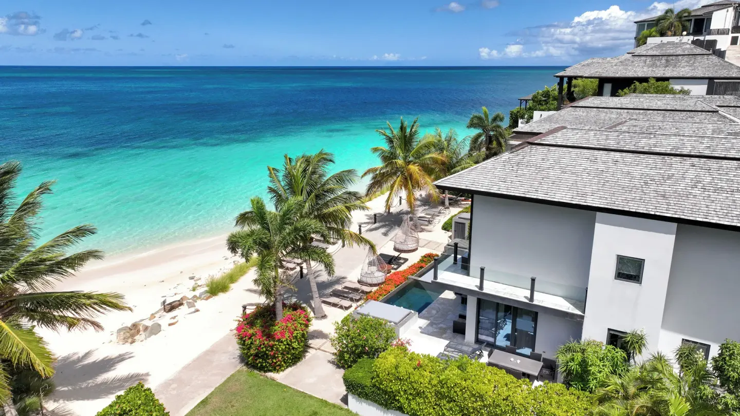 Beachfront villas above turquoise water at Tamarind Hills Resort & Villas.