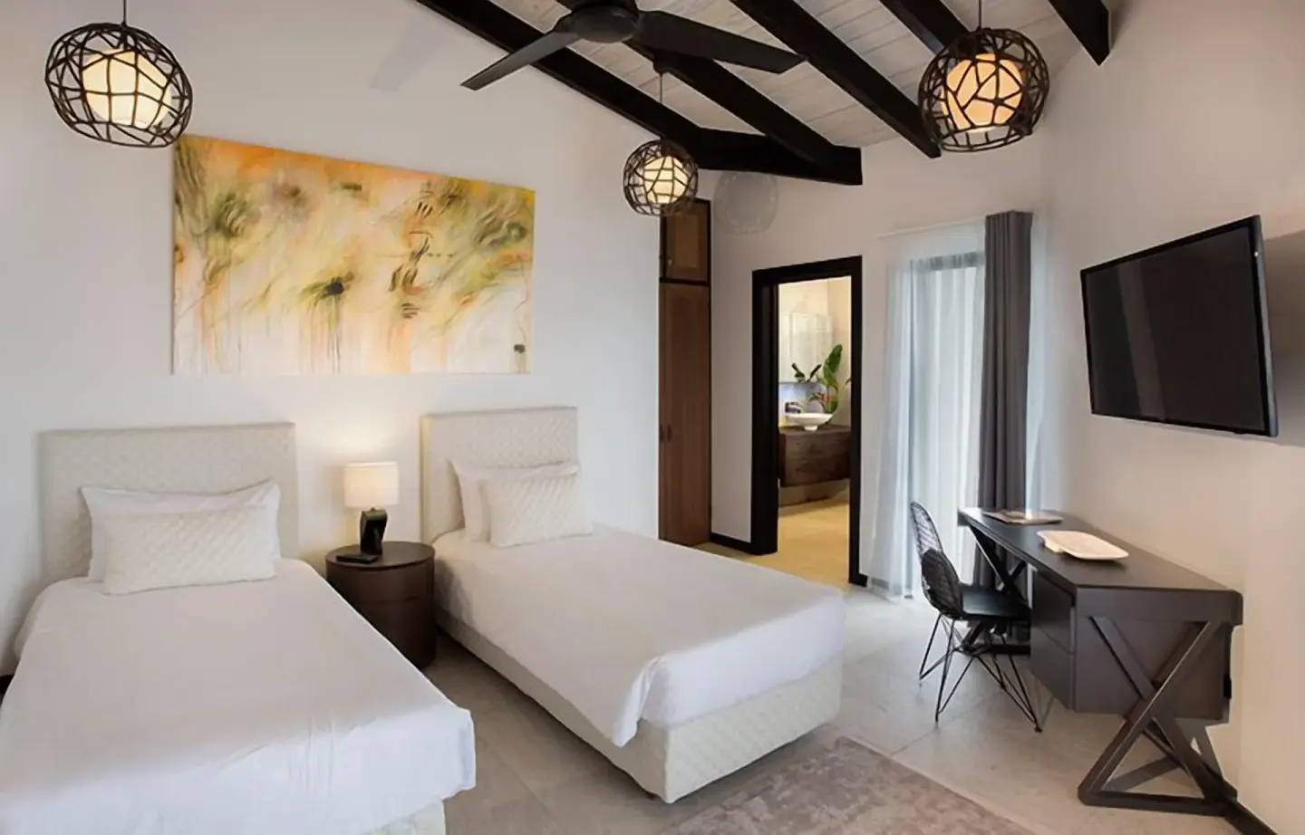 Twin bed guest room with vaulted ceiling at Tamarind Hills Resort & Villas.