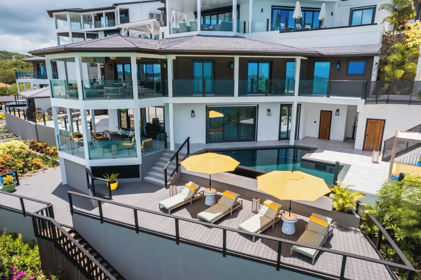 Private villa terrace with pool and yellow umbrellas at Tamarind Hills Resort & Villas.